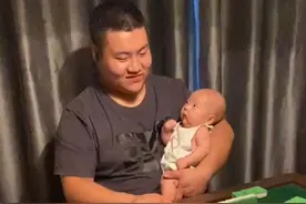 陕西一爸爸单手将宝宝抱怀里，另一只手摸牌打麻将，宝宝表情亮了图片